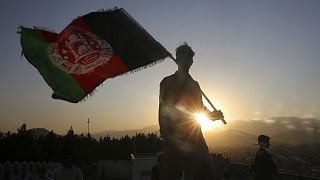 a man waves an Afghan flag during Independence Day celebrations in Kabul, Afghanistan.