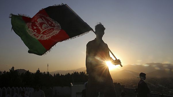 a man waves an Afghan flag during Independence Day celebrations in Kabul, Afghanistan. a man waves an Afghan flag during Independence Day celebrations in Kabul, Afghanistan.