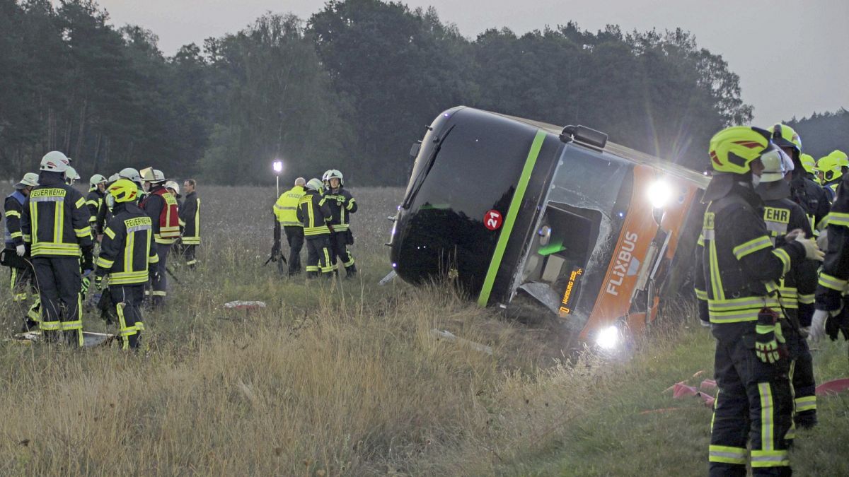 Firefighters are standing next to a long-distance bus on the A24 motorway in Woebbelin, northern Germany.