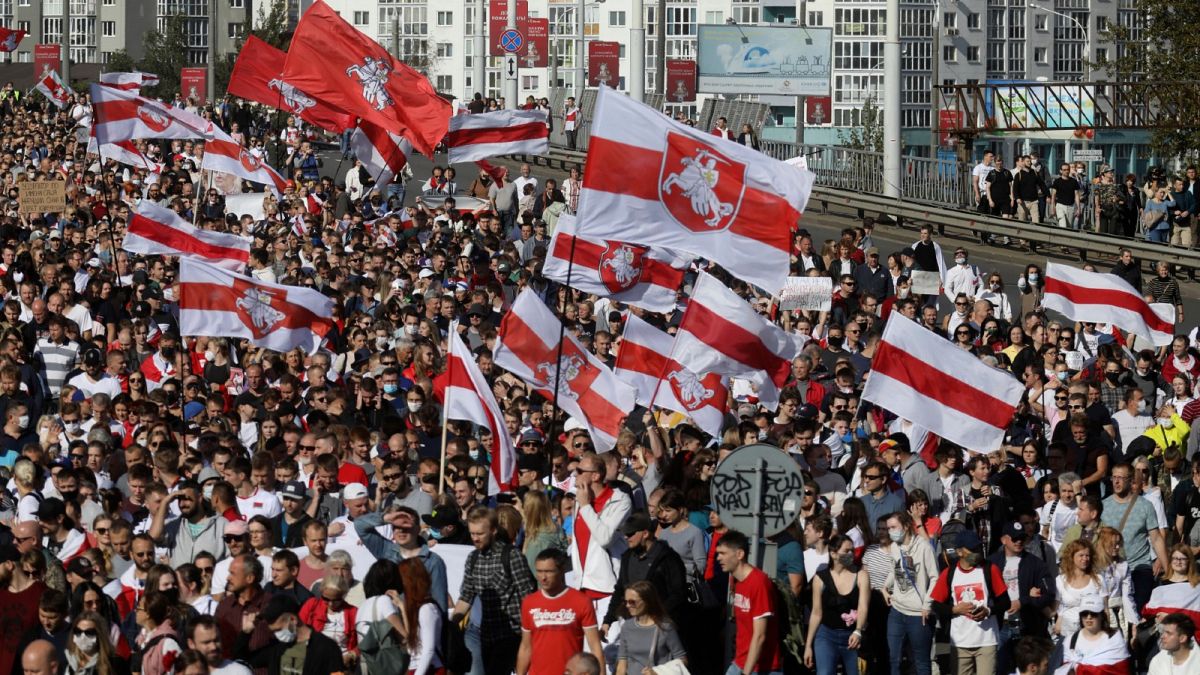 Protesters with old Belarusian national flags march during an opposition supporters' rally protesting election results in Minsk, Belarus. September 13, 2020.