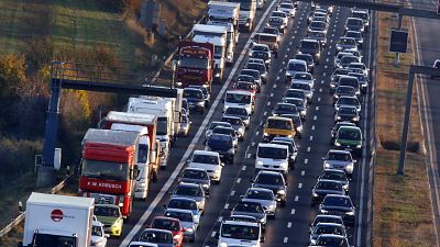 In this Nov. 6, 2017 file photo cars and trucks queue on the highway A5 in Frankfurt, Germany. 
