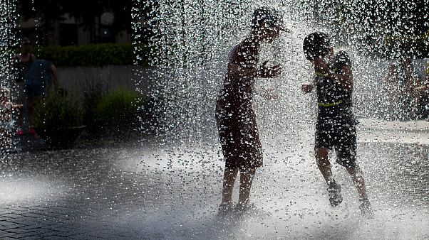 Lithuanian children cool off in a public fountain in Vilnius, Lithuania, Friday, June 19, 2020. Lithuanian children cool off in a public fountain in Vilnius, Lithuania, Friday, June 19, 2020.