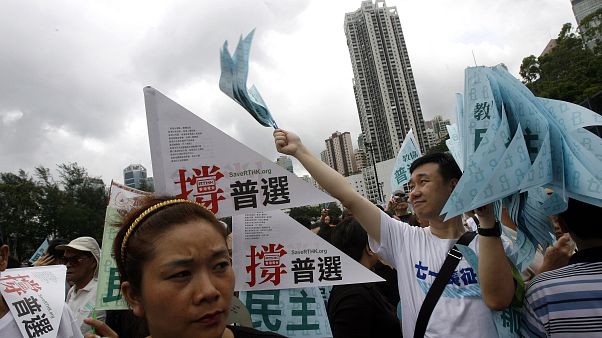 FILE: Thousands of people march in a Hong Kong downtown street, July 1, 2007. FILE: Thousands of people march in a Hong Kong downtown street, July 1, 2007.