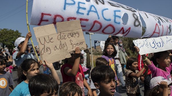Migrants shout slogans during a protest near Mytilene town, on the northeastern island of Lesbos, Greece, Monday, Sept. 14, 2020. Migrants shout slogans during a protest near Mytilene town, on the northeastern island of Lesbos, Greece, Monday, Sept. 14, 2020.