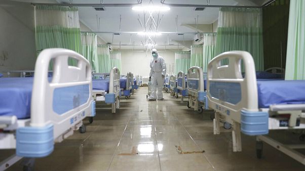 A medics inspects makeshift isolation rooms in Indonesia A medics inspects makeshift isolation rooms in Indonesia