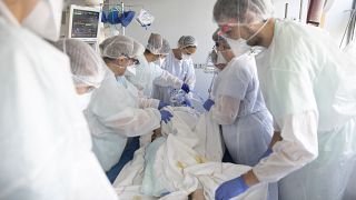 Medical workers tend a patient affected with the COVID-19 in the Nouvel Hospital Civil of Strasbourg, eastern France, Tuesday, Sept.15, 2020.