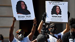 Signs are held up showing Breonna Taylor during a rally in her honour on the steps of the Kentucky State Capitol in Frankfort, Ky., Thursday, June 25, 2020.
