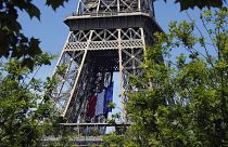 The French national flag decorates the Eiffel Tower