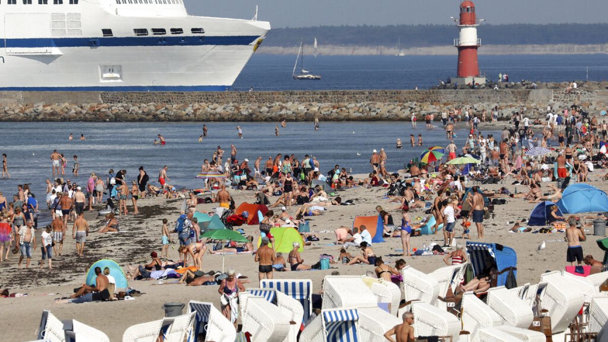 People enjoy the unusually warm late summer weather on the Baltic Sea beach  in Warnemuende, Germany