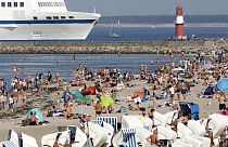 People enjoy the unusually warm late summer weather on the Baltic Sea beach  in Warnemuende, Germany