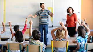 A teacher uses sign language at the start of the new school year in a special classroom for deaf children, in Ramonville in southwestern France