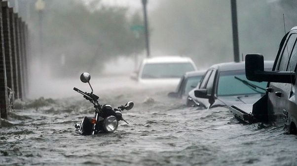 Cars and a motorcycle are underwater as water floods a street, in Pensacola, Fla., Wednesday, Sept. 16, 2020 Cars and a motorcycle are underwater as water floods a street, in Pensacola, Fla., Wednesday, Sept. 16, 2020