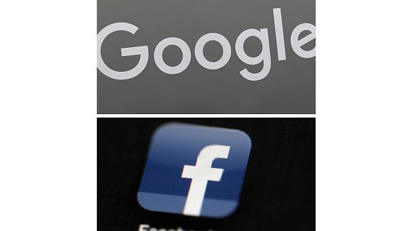 This combination of file photos shows a Google sign and the Facebook app. This combination of file photos shows a Google sign and the Facebook app.