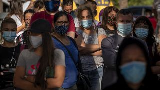 People wearing face masks wait their turn to be called for a PCR test for the COVID-19 in Barcelona, Spain on Monday Aug. 31, 2020.