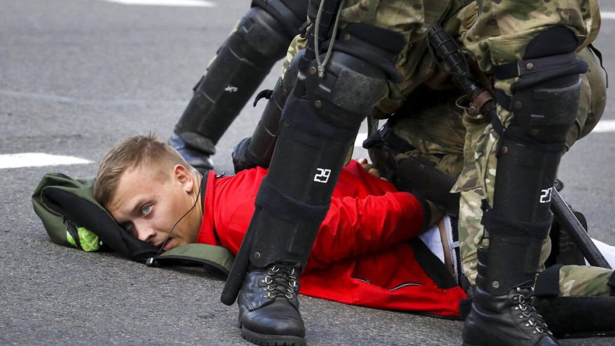 A protester is detained in Minsk during a Belarusian opposition supporters' rally on September 13