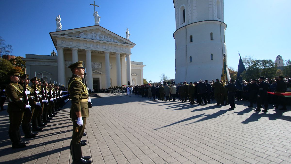 An honor guard stand as the coffin of the commander of the 1944-1953 partisan resistance movement against Soviet occupation, Adolfas Ramanauskas.