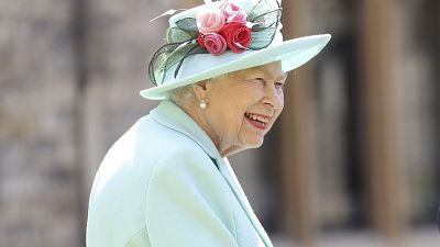 n this July 17, 2020 file photo, Britain's Queen Elizabeth smiles after awarding Captain Sir Thomas Moore his knighthood during a ceremony at Windsor Castle in England.
