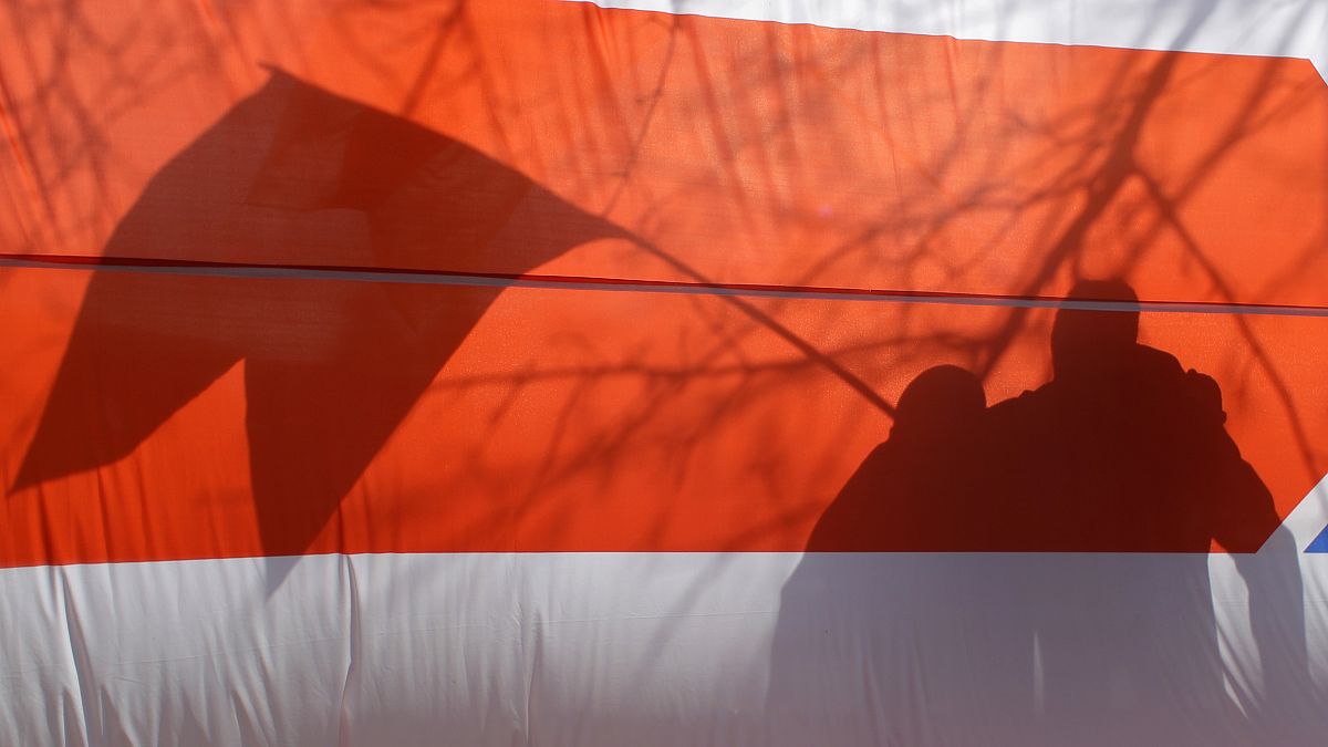 Бело-красно-белый флаг на акции в Минске 24 марта 2019