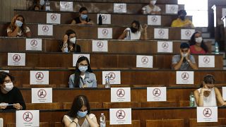 Students sit at a distance as a precaution against COVID-19, as they undergo an aptitude test to access the University of Medicine, in Rome Thursday, Sept. 3, 2020.