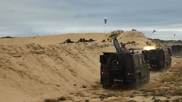 Soldiers in vehicles, firing heavy gun Soldiers in vehicles, firing heavy gun