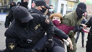 Police officers detain a woman during an opposition rally in Minsk on September 19, 2020.