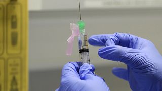 File photo: A COVID-19 vaccine is prepared to be administered to a volunteer, at a clinic in London. Aug 5, 2020.