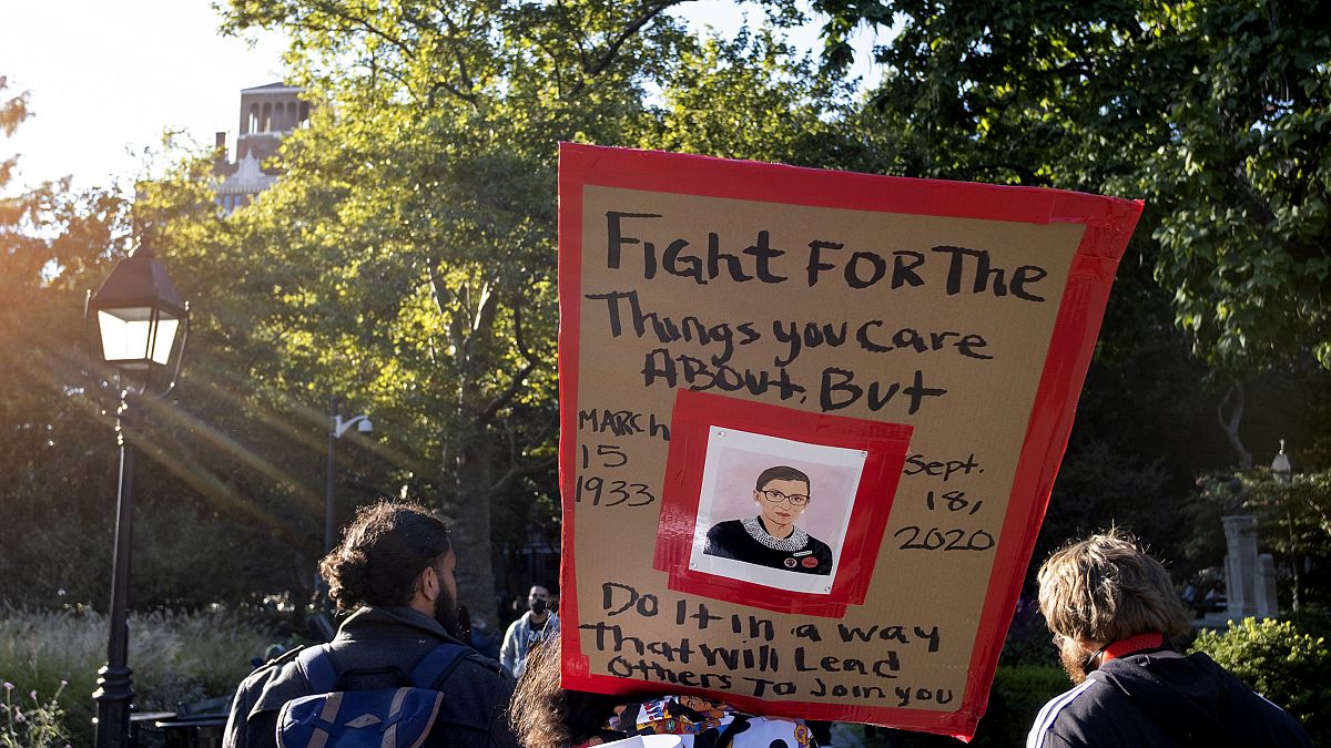 In this Sept. 19, 2020, file photo, a sign featuring a likeness of Justice Ruth Bader Ginsburg is carried in New York, a day after the death of the Supreme Court justice.