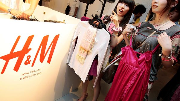 FILE: Shoppers on opening day of H&M's first Japan store in Tokyo's Ginza shopping district examine clothes, Sept. 13, 2008. FILE: Shoppers on opening day of H&M's first Japan store in Tokyo's Ginza shopping district examine clothes, Sept. 13, 2008.