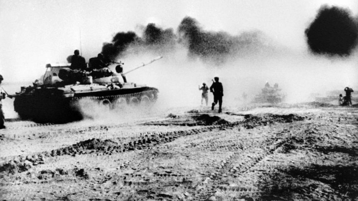 Iraqi tanks try to cross the Karun river in southwestern Iran on October 22, 1980 as smoke rises from an oil pipeline