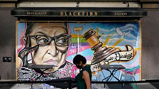 A mural in remembrance of Supreme Court Justice Ruth Bader Ginsburg covers plywood outside Blackfinn Ameripub, Monday, Sept. 21, 2020, in Washington. 