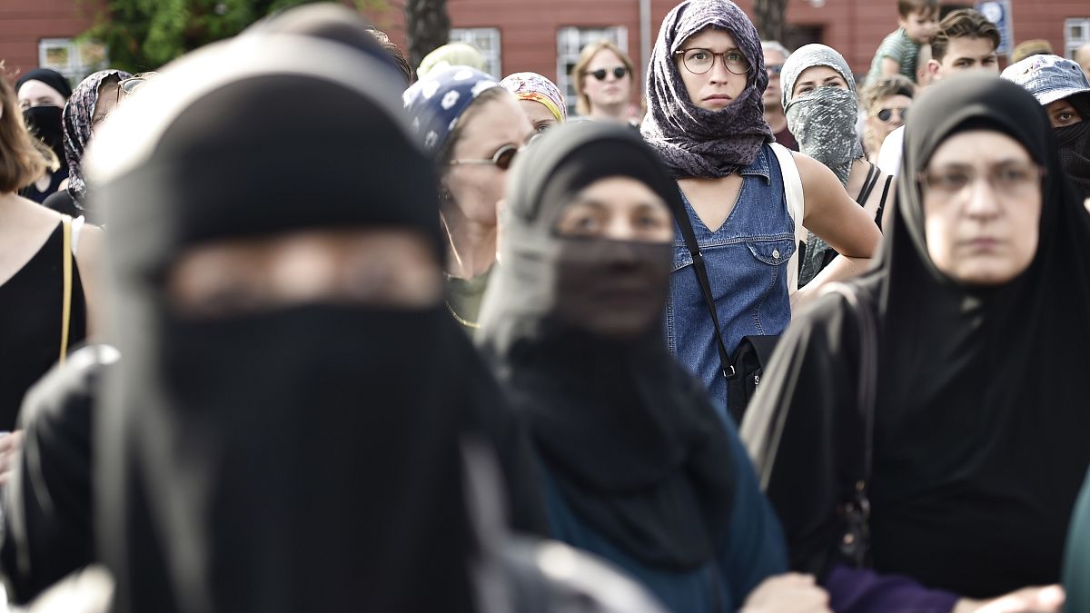 People demonstrate in Copenhagen, Denmark, Wednesday Aug. 1, 2018, as the new ban on garments covering the face is implemented.