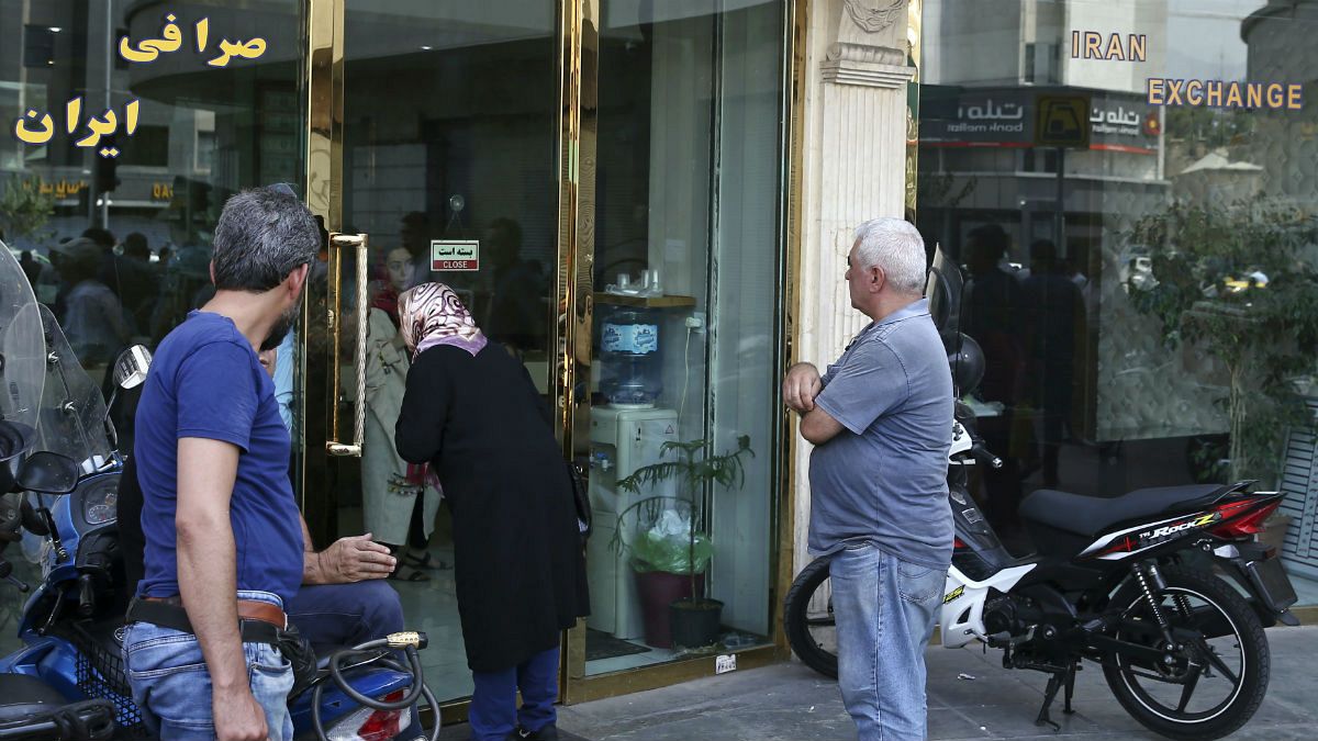 People wait in front of a closed money exchange shop for it to open, in downtown Tehran, Iran