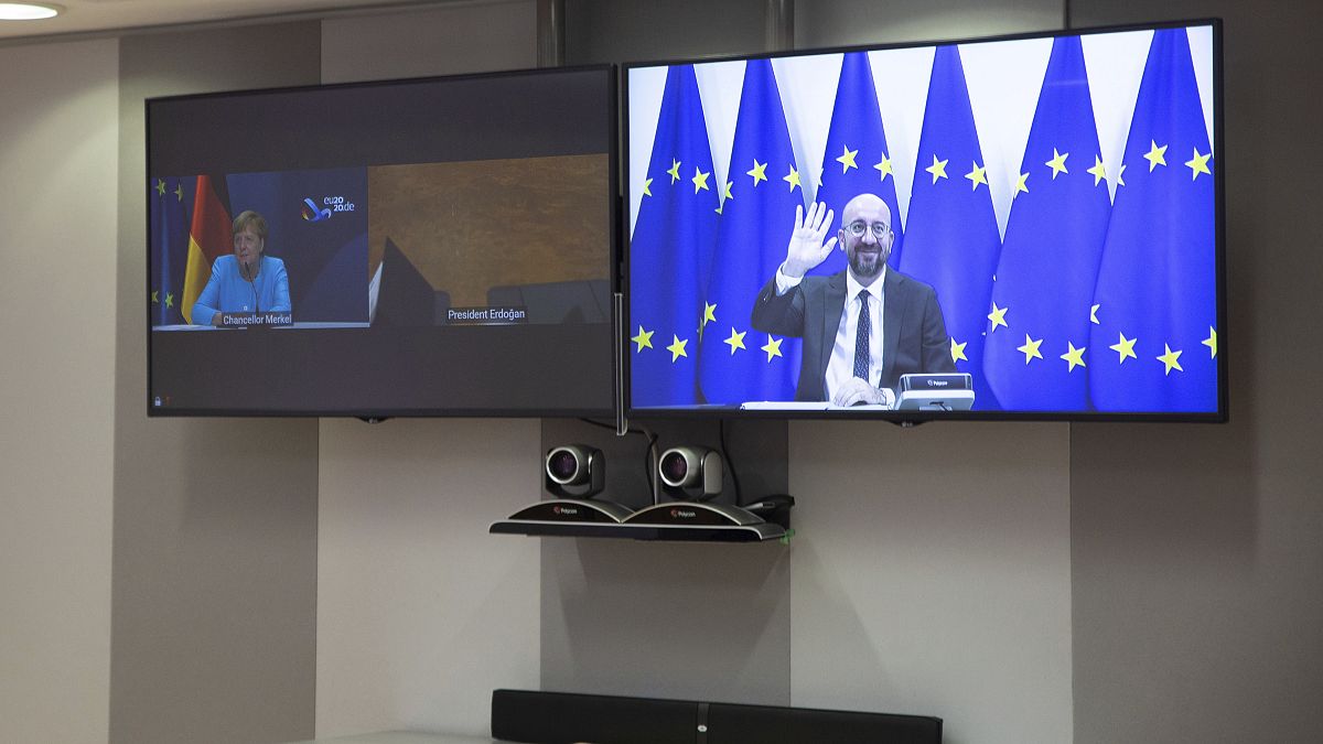 European Council President Charles Michel, screen right, waves as he attends a video conference with German Chancellor Angela Merkel, Sep 22 2020