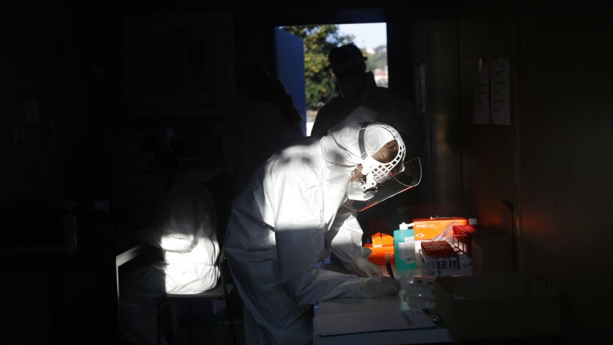 A healthcare worker at a sampling station for COVID-19 in Prague, Czech Republic, Monday, Sept. 21, 2020. 