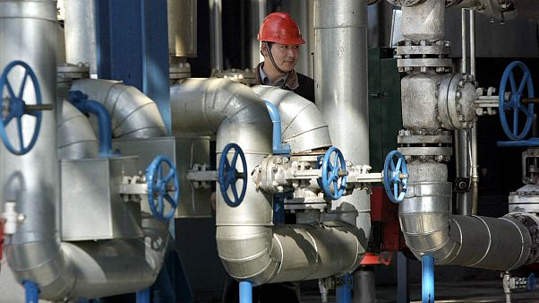 A Chinese worker walks past equipment at an oil refinery of the PetroChina A Chinese worker walks past equipment at an oil refinery of the PetroChina
