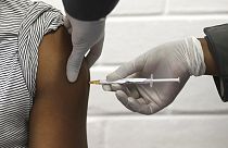 FILE - In this Wednesday, June 24, 2020 file photo, a volunteer receives an injection at the Chris Hani Baragwanath hospital in Soweto, Johannesburg.