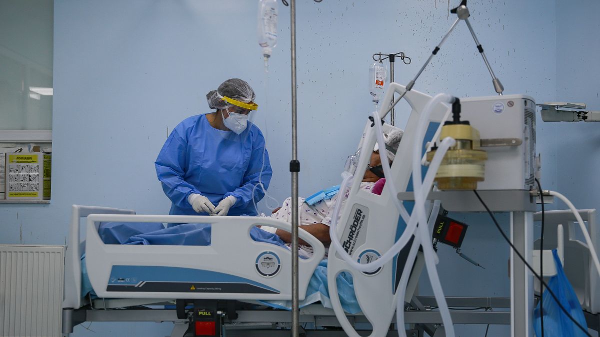 A nurse inside the Intensive Care Unit attends to a patient with COVID-19 in the Clinic for Infectious Diseases, in Pristina, Kosovo, Sept. 21, 2020.