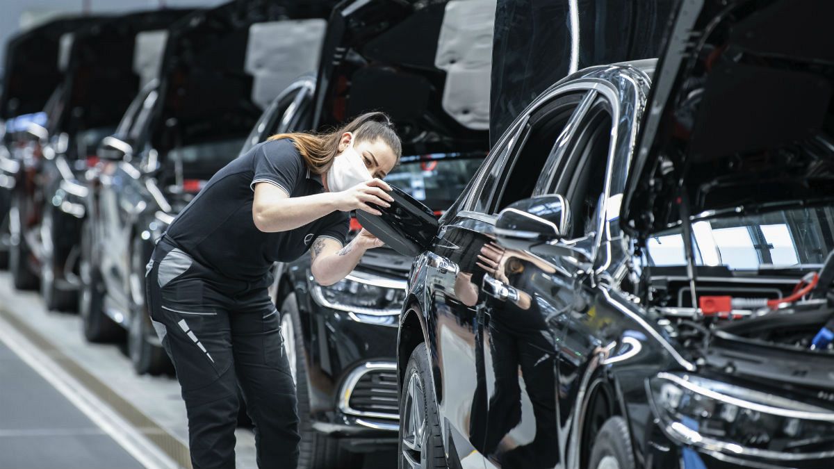 A Mercedes-Benz employee is working on a fuel cap cover for an S-Class at the "Factory 56" plant in Sindelfingen, Germany