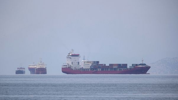 A cargo ship approaches the port of Piraeus as other ships are anchored, near Athens, Greece in this May 26, 2020 file photo. A cargo ship approaches the port of Piraeus as other ships are anchored, near Athens, Greece in this May 26, 2020 file photo.
