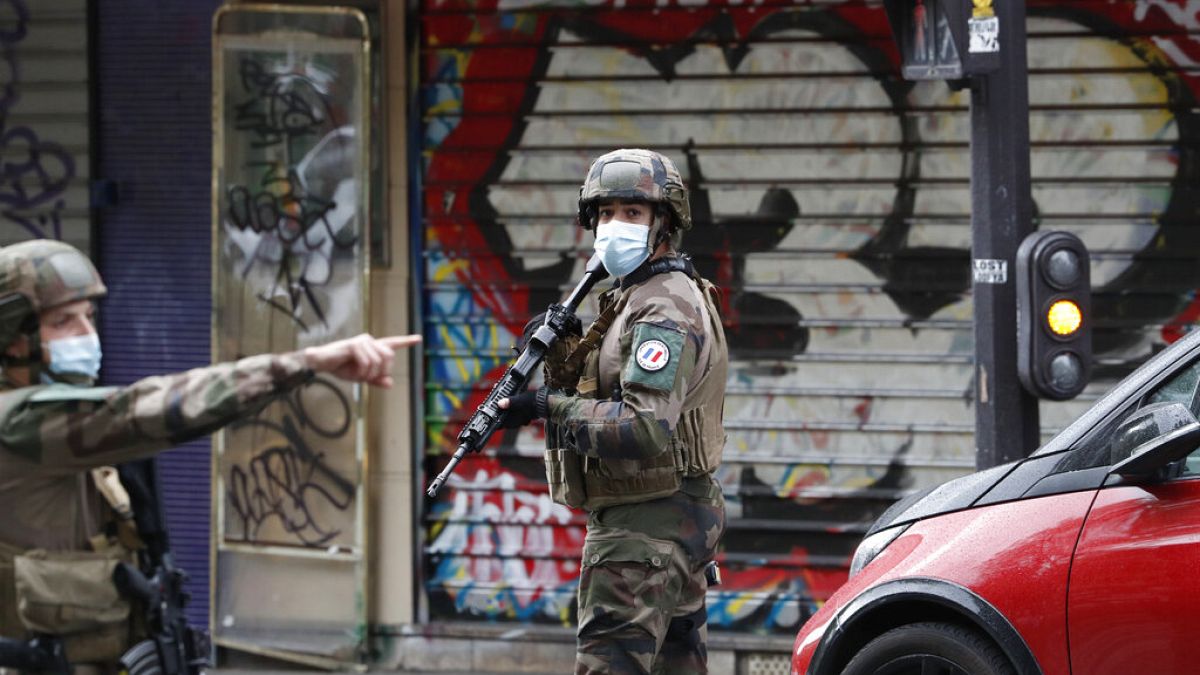 French soldiers patrol an area in Paris after four people were injured in a knife attack