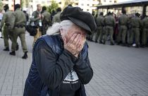 An elderly woman reacts as police officers detain women during an opposition rally to protest the official presidential election results in Minsk, Belarus, Saturday, Sept. 19,