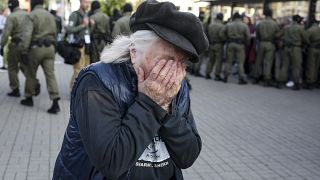 An elderly woman reacts as police officers detain women during an opposition rally to protest the official presidential election results in Minsk, Belarus, Saturday, Sept. 19,