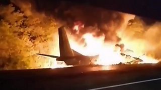 In this TV grab released by Ukraine's Emergency Situation Ministry, an AN-26 military plane bursts into flames after it crashed in the town of Chuhuyiv, Ukraine, Sept 25, 2020