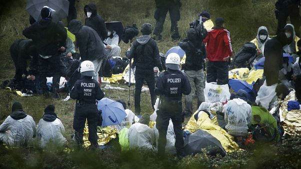 Activists are surrounded by police on the Garzweiler power plant grounds in Grevenbroich, western Germany, Saturday, Sept. 26, 2020. Activists are surrounded by police on the Garzweiler power plant grounds in Grevenbroich, western Germany, Saturday, Sept. 26, 2020.
