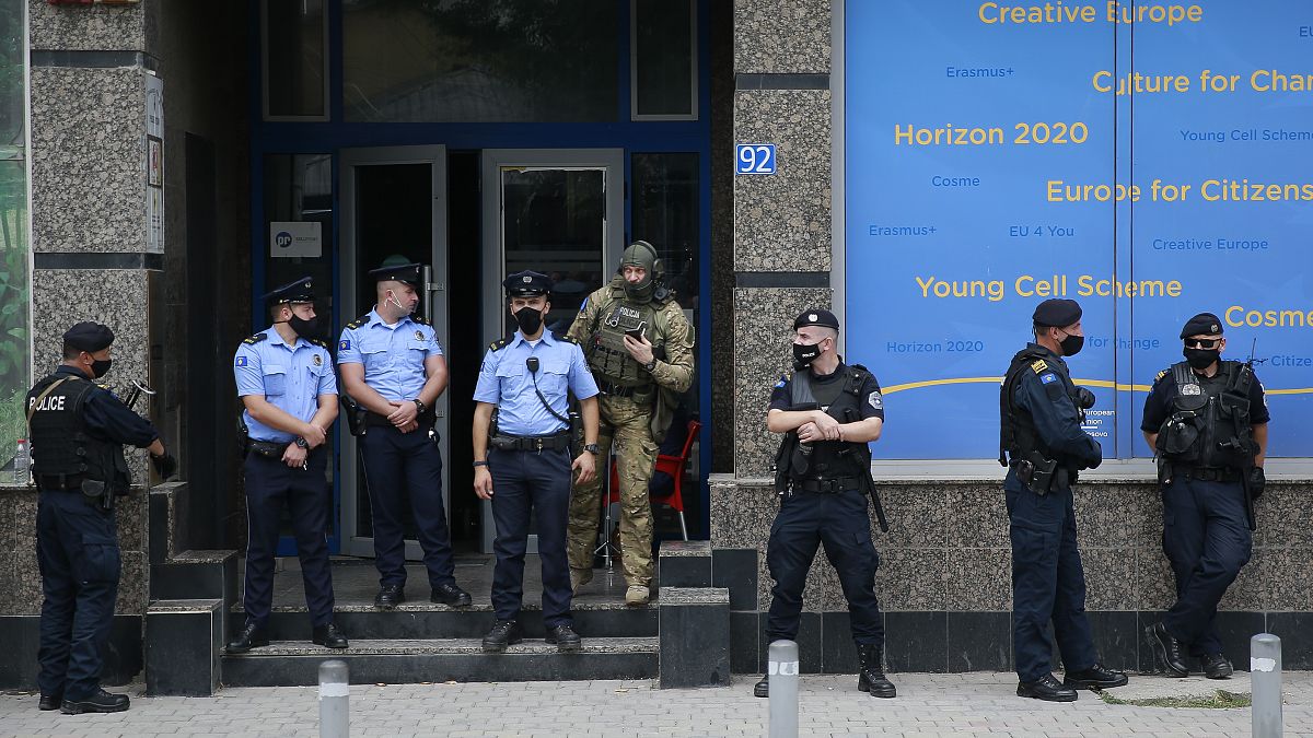Kosovo police guard the entrance of the offices of a war veterans association in Kosovo, in Pristina.