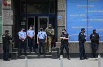 Kosovo police guard the entrance of the offices of a war veterans association in Kosovo, in Pristina, Friday, Sept. 25, 2020.