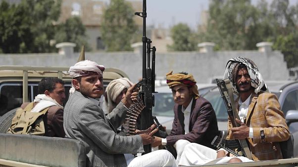 FILE - In this Aug. 22, 2020 file photo, tribesmen loyal to Houthi rebels hold their weapons as they ride in a vehicle. FILE - In this Aug. 22, 2020 file photo, tribesmen loyal to Houthi rebels hold their weapons as they ride in a vehicle.