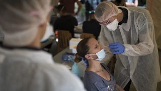 A woman is tested for COVID-19 at a mobile testing center in Marseille, France, Thursday Sept. 24, 2020.