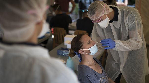 A woman is tested for COVID-19 at a mobile testing center in Marseille, France, Thursday Sept. 24, 2020. A woman is tested for COVID-19 at a mobile testing center in Marseille, France, Thursday Sept. 24, 2020.