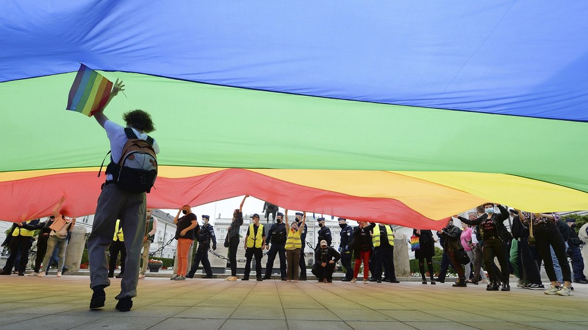 Pro-LGBT demonstrators display a huge rainbow flag as they take part in a protest against hatred towards LGBT people in Warsaw on August 30, 2020.